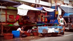 All in a day's work. A man and a woman were cleaning up their makeshift stall in Manila after selling their goods. Stalls along streets are common in many places in the country and they are often referred to as "talipapa."